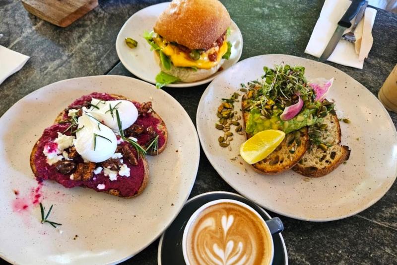 サワードウブレッドのトースト ローストしたビーツとポーチドエッグ添え（左）、Wagyu Beefチーズバーガー（中）、ピスタチオやひまわりの種などが入った全粒粉サワードウブレッドのトースト フレッシュアボカド添え（右）